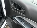 Interior door handle and power window controls of a 2019 Chevrolet Colorado