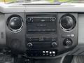 Dashboard of a 2012 Ford F-550 featuring radio controls air conditioning knobs and various buttons for vehicle settings