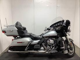 A 2015 Harley-Davidson FLHTKL motorcycle featuring a silver and black design with a comfortable two-seat arrangement and equipment for touring