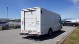 A white 2006 Ford Econoline cargo van parked in a lot with a damaged rear door and no visible company branding