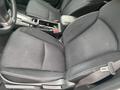 The interior of a 2014 Subaru Impreza featuring black fabric seats with a central console and gear shifter visible