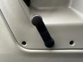 A black manual lever for adjusting the seat positioned on a beige surface in a 2008 Sterling Acterra vehicle