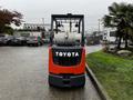 A 2017 Toyota 8FCGCU25 forklift with a red and black exterior featuring a propane tank mounted on the back and large front wheels