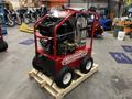 A red 2024 Magnum 4000 Hot Water Pressure Washer mounted on a wooden pallet with large wheels and various controls on top