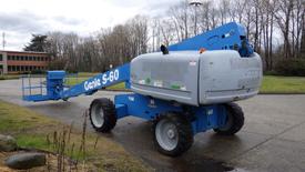 A blue 2007 Genie S-60 aerial lift with a long extended arm and platform for working at heights.