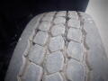 Close-up of a worn tire tread from a 2008 International 7400 showing deep grooves and significant wear indicating usage on road surfaces