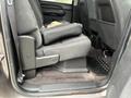 Interior view of the back seat of a 2013 Chevrolet Silverado Hybrid showing a black fabric seat and floor mats