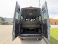 A 2019 Mercedes-Benz Sprinter van with rear doors wide open revealing a spacious interior with rows of black seats.