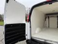 2009 Chevrolet Express cargo van with an open rear door revealing a spacious empty interior designed for transport and storage