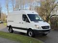 A white 2012 Mercedes-Benz Sprinter van with a streamlined body and distinctive grille parked on a driveway