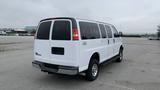 A white 2017 Chevrolet Express Quigley 4x4 van with multiple windows and a rear hatchback door