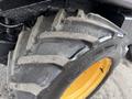 Close-up of a textured, worn tire from a 1994 John Deere F1145 featuring a large lug design and bright yellow rim