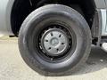 Close-up view of a black tire and wheel from a 2019 Mercedes-Benz Sprinter branded with the Mercedes logo on the hubcap