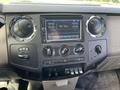 Dashboard of a 2010 Ford F-550 featuring a radio display knobs for climate control and various function buttons