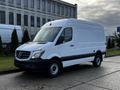 A white 2017 Mercedes-Benz Sprinter van with a tall body and black accents parked in an outdoor setting