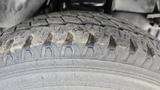 Close-up of a worn tire tread on a 2006 Ford Econoline showcasing visible grooves and wear patterns indicating usage and aging of the tire