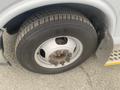 A close-up of the wheel and tire of a 2017 Chevrolet Express showing the tire tread and silver wheel rim with bolts