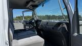 Interior of a 2006 Ford LCF 550 showing the driver's seat and dashboard with steering wheel and control panels