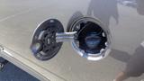 A close-up view of the fuel filler cap on a 2014 RAM 3500 showing the fuel nozzle and cap mechanism