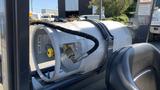 A white propane tank secured to the side of a 2018 Toyota 8FGCU25 forklift with a yellow valve and a black hose connected to it