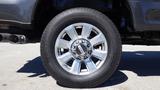 Close-up of a 2017 Ford F-350 SD wheel showing a silver alloy rim and a black tire with visible tread pattern