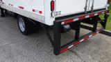 A 2016 Hino 195 truck featuring a white box trailer with red and white reflective striping and a sturdy black rear bumper assembly