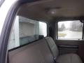 Interior view of a 2009 Ford F-450 SD truck showing the rear seating area with fabric upholstery and a seatbelt