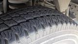 Close-up of a tire from a 2011 Ford Econoline showing detailed tread pattern and sidewall texture