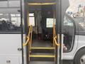 Interior view of a 2017 Chevrolet Express showing the entrance steps and driver's seat with yellow handrails for support