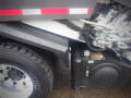 Close-up of a 2008 International 7400 truck showing a wheel, undercarriage components, and hydraulic lines