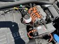 A 2016 Audi A3 engine compartment featuring the e-tron hybrid system with orange electrical cables and various components visible