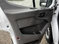 Interior door panel of a 2021 Ford Transit showcasing a gray textured surface and handle