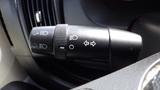 A control stalk for lights and turn signals in a 2017 RAM Promaster with various symbols and a textured grip