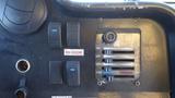 Control panel of a 2006 Ford Econoline featuring buttons for lights and door along with a horizontal slider for temperature control