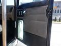 A close-up view of the driver's side door of a 2008 Peterbilt 335 showing the door handle and interior panel features