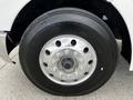 Close-up of a tire and wheel assembly from a 2014 Kenworth T370 showcasing a shiny metal rim and robust black rubber tire