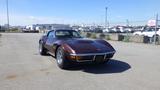 A 1971 Chevrolet Corvette Stingray in a deep brown color with a sleek design and distinctive front grille and headlights