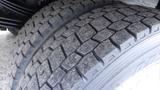 Close-up view of a 2016 Hino 195 tire showing a detailed tread pattern with some visible wear and dirt on the surface