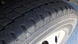 A close-up of a tire from a 2006 Ford Econoline highlighting the tread pattern and sidewall details