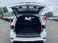 A 2018 Jeep Grand Cherokee with its rear hatch open revealing an empty cargo space