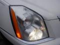 Close-up of a 2008 Cadillac Limousine headlight with moisture on the surface showcasing the orange turn signal and clear lens