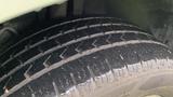 Close-up view of a tire from a 2013 Lincoln MKT showing tread patterns and surface details