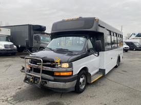 A 2017 Chevrolet Express with a black and white exterior featuring a front push bar and distinctive headlights