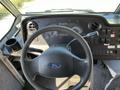 Interior view of a 2011 Ford Econoline showing the steering wheel dashboard and control panel