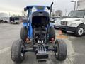 2007 New Holland TN70A tractor with an open engine compartment showing the engine and rear axle view