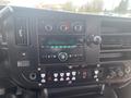 The interior dashboard of a 2017 Chevrolet Express featuring controls for radio climate and various switches