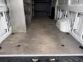 A 2019 Mercedes-Benz Sprinter van with an empty cargo area featuring metal shelves along one side and a smooth floor