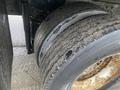 Close-up of a worn tire with visible tread wear and damage on a 2018 International 26 Foot Cube Air Brakes truck