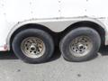 Two large wheels with silver rims and worn tires from a 2010 Forest River Enclosed trailer