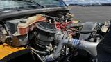 Close-up of the engine compartment of a 2014 Freightliner Thomas Bus Diesel showing various components including the radiator reservoir and air filter assembly